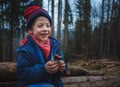 Little boy eating a candy bar on a mountain forest trip. Royalty Free Stock Photo