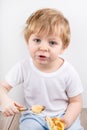 Little boy eating cheesecake muffin. Royalty Free Stock Photo