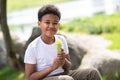 Little boy eating ice cream in park on hot summer day, enjoying sweet dessert during summer holidays. Royalty Free Stock Photo