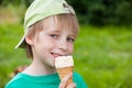 Little boy eating ice cream in the park outdoors Royalty Free Stock Photo