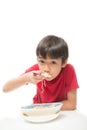 Little boy eating instant noodle on white background