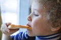 Little boy eating pizza in a cafe, closeup portrait, photograph Royalty Free Stock Photo