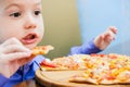 Little boy eating pizza at cafe Royalty Free Stock Photo