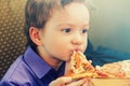 Little boy eating pizza at cafe Royalty Free Stock Photo