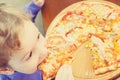 Little boy eating pizza at cafe Royalty Free Stock Photo