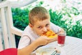 Little boy eating pizza in a cafe Royalty Free Stock Photo