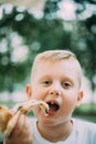 Little Boy Eating Pizza In Cafe In Summer Day Royalty Free Stock Photo