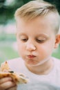 Little Boy Eating Pizza In Cafe In Summer Day Royalty Free Stock Photo