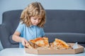 Little boy eating pizza. Cute little boy eats pizzas. Happy handsome young teen boys holding slice pizza. Little boy Royalty Free Stock Photo