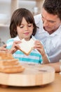 Little boy eating a sandwich with his father Royalty Free Stock Photo