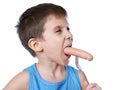 Little boy eating a sausage from fork isolated