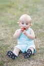 Little boy eating watermelon red in the garden sitting on the grass. The boy is ten months Royalty Free Stock Photo