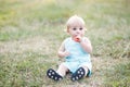 Little boy eating watermelon red in the garden sitting on the grass. The boy is ten months Royalty Free Stock Photo