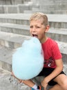 Boy eating white sweet cotton