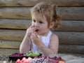 Little boy eats red raspberry Royalty Free Stock Photo