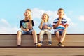 Little boy and elder brothers eat ice cream sit on bench watching movie Royalty Free Stock Photo