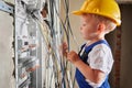 Child repairing electric panel in apartment under renovation. Royalty Free Stock Photo