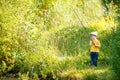 Little boy is engaged in fishing in a pond. Child with a dairy i Royalty Free Stock Photo