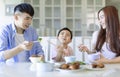 Little boy  enjoy eating food with father and mother. Happy Asian  family having dinner at home Royalty Free Stock Photo