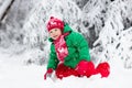 Little boy enjoying a sleigh ride. Child sledding. Toddler kid riding a sledge. Children play outdoors in snow. Kids sled in the Royalty Free Stock Photo