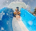Little boy enjoying water slide during family vacation. Royalty Free Stock Photo