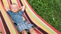 Little Boy enjoys free time in hammock