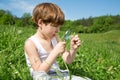 Little Boy Exploring Field Flowers With Magnifying Glass On Beautiful Green Field Royalty Free Stock Photo