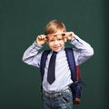 Little Boy in eyeglasses with big backpack