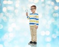 Little boy in eyeglasses with magnifying glass Royalty Free Stock Photo