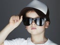 Little boy. fashion children.handsome in sunglasses and Tracker Hat. Child in Cap Royalty Free Stock Photo