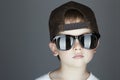 Little boy. fashion children.handsome in sunglasses and Tracker Hat. Child in Cap Royalty Free Stock Photo