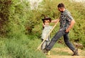 Little boy and father in nature background. Spirit of adventures. Little helper in garden. Child having fun cowboy dad