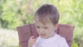 Little boy during feeding spits tasteless food