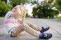 Little boy fell in the street, hit his head. Injury Royalty Free Stock Photo