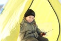 Little boy fishes in a tent Royalty Free Stock Photo