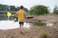 A little boy with a fishing net walks Royalty Free Stock Photo