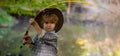 Little boy is fishing at sunset on the lake. Cute boy fishing from a dock on a lake or pond. Beautiful child with Royalty Free Stock Photo