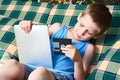 Little boy with floppy disk and tablet pc Royalty Free Stock Photo