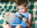 Little boy with floppy disk and tablet pc Royalty Free Stock Photo