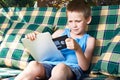 Little boy with floppy disk and tablet pc Royalty Free Stock Photo