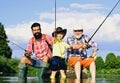 Little boy fly fishing on a lake with his father and grandfather. Summer day. Happy grandfather, father and grandson Royalty Free Stock Photo