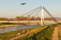 A little boy flying his Kite on a river bank walkway at sunset, during the outbreak of Corona Virus