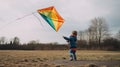 A little boy flying a kite in a field. Generative AI image. Royalty Free Stock Photo