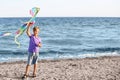 Little boy flying kite near sea Royalty Free Stock Photo