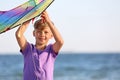 Little boy flying kite near sea Royalty Free Stock Photo