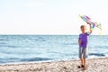 Little boy flying kite near sea Royalty Free Stock Photo