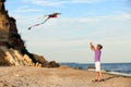 Little boy flying kite near sea Royalty Free Stock Photo