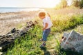 Little boy flying towards the ground to land on his feet. side view Royalty Free Stock Photo