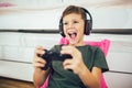 Boy with gamepad playing video game at home Royalty Free Stock Photo