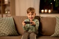 Little boy with gamepad playing video game at home Royalty Free Stock Photo